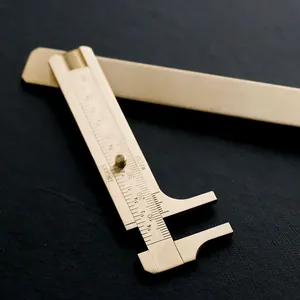 Vintage mini brass vernier caliper tool with dual inch and metric measurement scales
