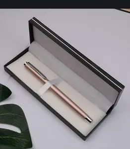 Close-up of a elegant rose gold metal ballpoint pen inside a premium black gift box set.
