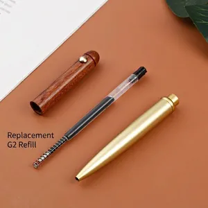 Dismantled vintage brass and sandalwood rollerball pen with a replaceable G2 ink refill