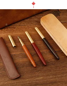 Luxury vintage sandalwood fountain pens with elegant brass caps and leather case.