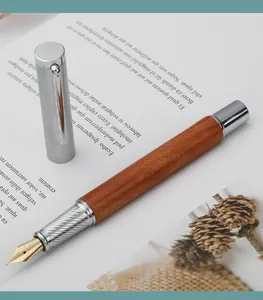 Close-up detail of a professional rosewood fountain pen with silver textured grip