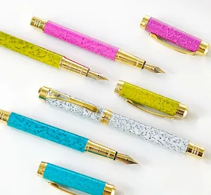 Detailed view of luxury fountain pens with colorful marble patterns and gold accents