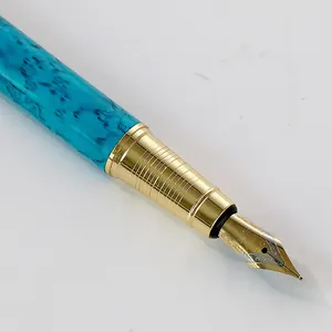 Luxury turquoise marble pattern fountain pen with an engraved gold nib, perfect for business gifts