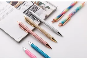 Assorted glitter and mermaid pattern retractable ballpoint pens in elegant display.
