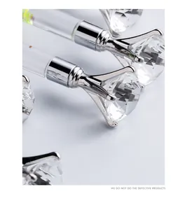 Close-up of elegant crystal diamond-top ballpoint pens with metallic finish