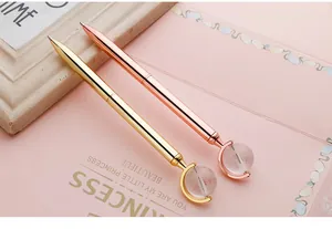 Elegant metal ballpoint pens with rotating crystal globe ornament in gold and rose gold