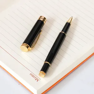 Premium classic black and gold metal rollerball pen on memo notebook for business use