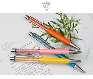 Detailed macro view of colorful crystal metal ballpoint pens with rhinestone filling