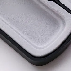 Close-up of flip-top magnetic gift pen box interior with soft grey flocked lining texture