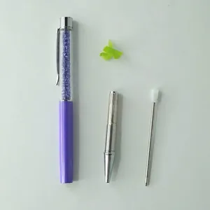 Elegant purple crystal ballpoint pen with rhinestone barrel, metal tip, and ink refill