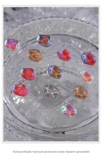 Detailed macro view of iridescent water-ripple nail art stones in assorted candy colors.