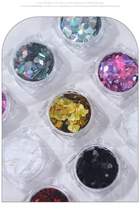 Macro view showing a collection of ultra-thin holographic heart nail sequins in clear jars