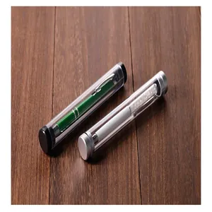 Detail view of cylindrical transparent cases with black and silver caps on wood surface