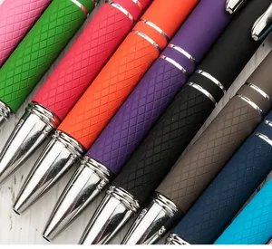 Macro view of colorful retractable ballpoint pens with diamond-patterned rubber grips