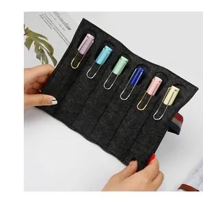 Detail view of a multi-slot dark grey felt pen pouch holding colorful pens neatly