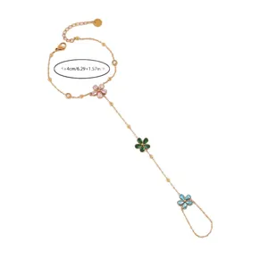 Elegante pulsera de dedo en acero dorado con tres dijes de flores de circón de colores