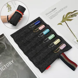 Minimalist grey felt roll-up pen case with multi-slot storage and striped elastic strap