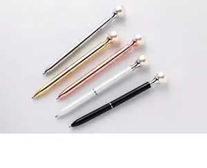 Detailed macro view showing a collection of elegant pearl-topped metal ballpoint pens in five colors