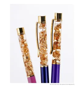 Close-up of three gold leaf liquid pens with metallic finishes in various colors.