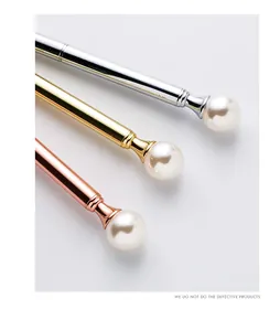 Detail view of pearl metal ballpoint pens in silver, gold, and rose gold finish.