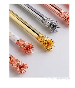 Detailed close-up of decorative pineapple-shaped metal toppers on luxury pens