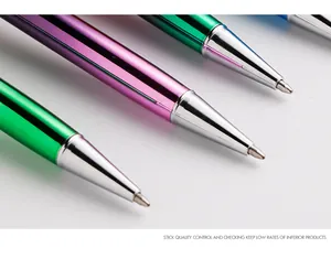 Detailed macro shot of metal ballpoint pen tips featuring colorful metallic barrels