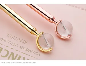 Close-up of elegant metal globe ballpoint pens in gold and rose gold gift finish