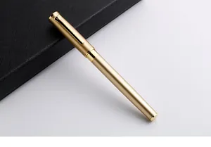 Elegant matte gold metal rollerball pen detail on black business notebook background