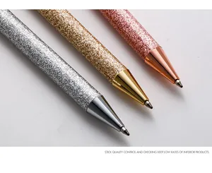 Macro view of sparkly glitter ballpoint pens in silver, gold, and rose gold finish