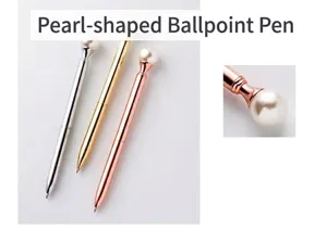 Detail shot of elegant metallic ballpoint pens featuring a decorative pearl top