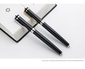 Detailed view showing professional black metal rollerball pens with gold and silver trim accents.