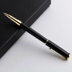 Professional black and gold metal rollerball pen resting on a textured black gift box