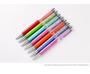 Detailed macro view of colorful metal ballpoint pens with decorative crystal fills