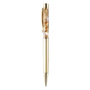 Elegant twist-action metallic ballpoint pen featuring decorative floating gold foil flakes