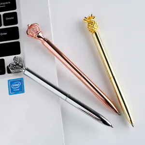 Set of creative metal ballpoint pens with crown, heart, and pineapple shaped decorative tops.