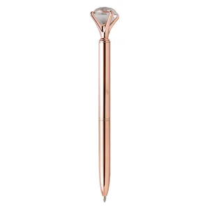 Elegant rose gold metal ballpoint pen topped with a large sparkling glass diamond