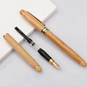 Elegant natural bamboo fountain pen with gold trim and refillable ink converter system