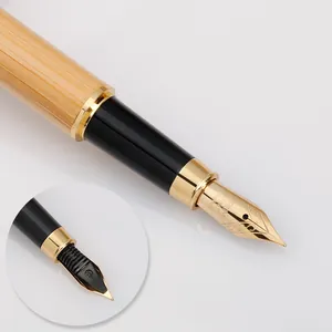 Professional bamboo fountain pen featuring gold metallic accents and iridium point nib