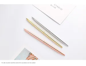 Close-up of three slim metal ballpoint pens in rose gold, gold, and silver finishes
