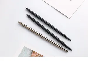Detailed view of minimalist slim metal ballpoint pens in black and gunmetal grey.