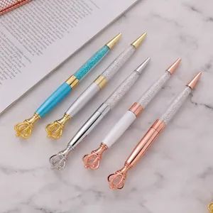 Elegant metal ballpoint pens with decorative crown toppers and crystal filled barrels