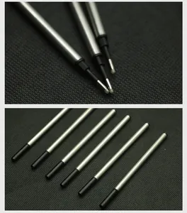 Close-up detail of 11.2cm silver metal ballpoint pen refills on black fabric background