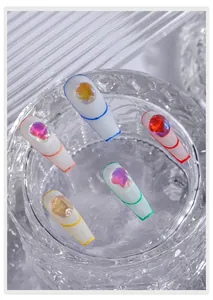 Close-up of irregular aurora ice cube gems on matte white nail tips with colored borders
