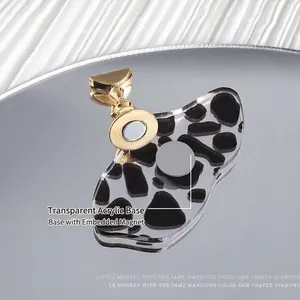 Magnetic cow print nail practice stand with gold metal holder and clear acrylic base