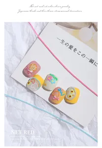 Close-up macro view of colorful decorative chains for Japanese-style 3D nail art designs
