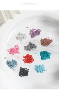 Close-up view of various colorful 3D metal nail art chains displayed on a white plate