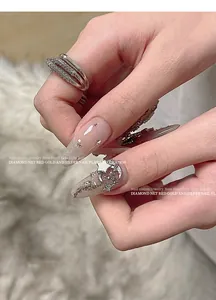 Close-up of elegant silver star and moon nail art jewelry with sparkling zircon stones