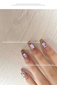 Close-up of purple rectangular aurora flat back rhinestones on French manicure nails