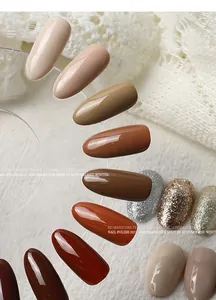 Close-up of caramel and cocoa brown gel nail polish swatches on a fan display.