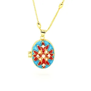 Detailed macro shot of an ornate blue and red enamel oval locket with faux pearls.